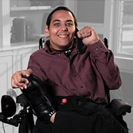 An adult male with limited mobility using Speech to Speech services